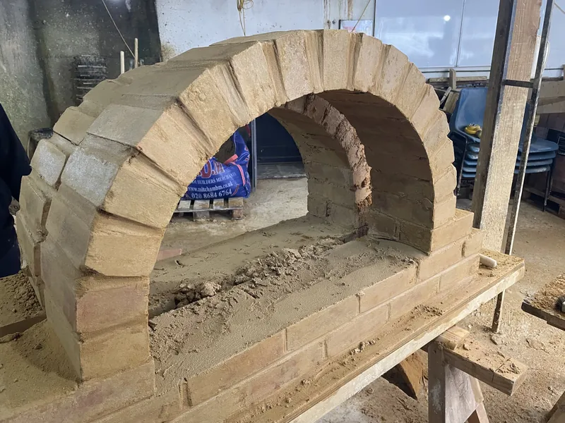 Hand-built brick arch for a feature fireplace