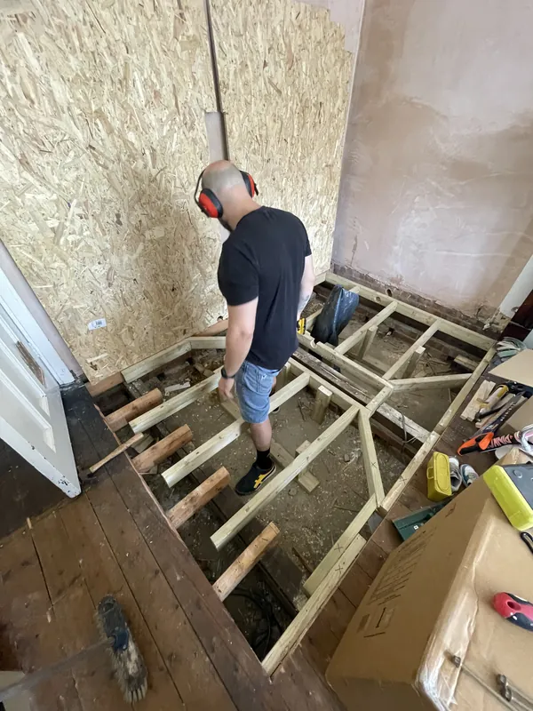 Working alongside a homeowner on a floor renovation