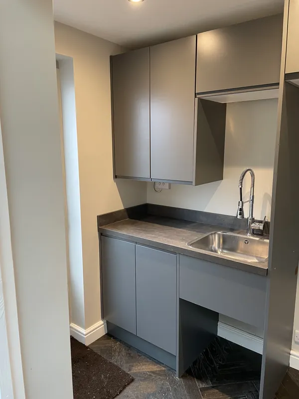 Utility room fitted with grey units and sink